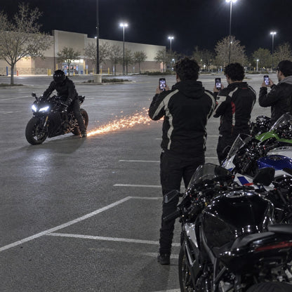 Friends filming the sparks at a bike meet